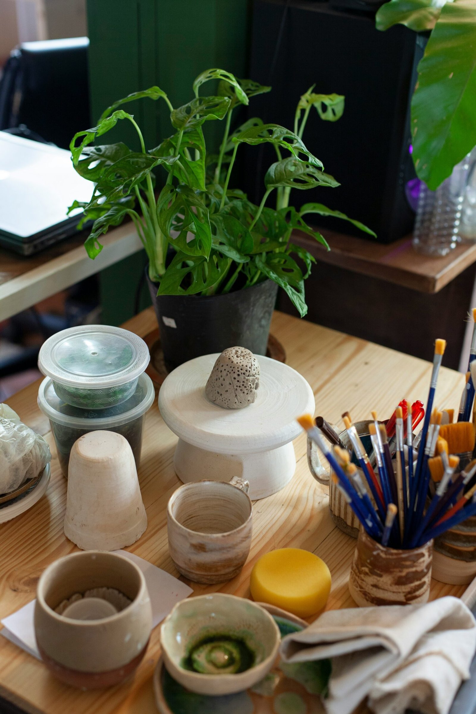 a wooden table topped with lots of craft supplies